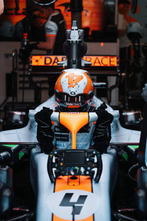 F1 Lando Norris Entering Mclaren Iphone Wallpaper