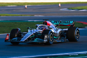 F1 Master Lewis Hamilton In Action Wallpaper