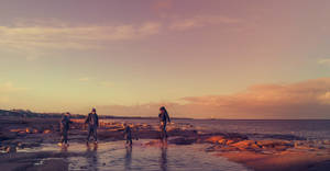 Family Outing At The Beach Wallpaper