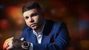 Farruko On Dark Blue Suit Wallpaper