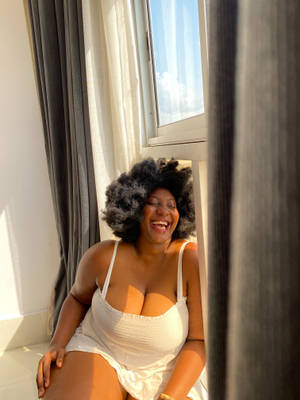 Fat Black Woman By Window Wallpaper