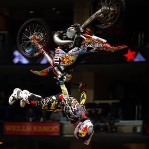 Fearless Motocross Rider Soaring In The Sky At X Games Wallpaper