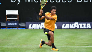 Felix Auger-aliassime In Action On The Tennis Court Wallpaper