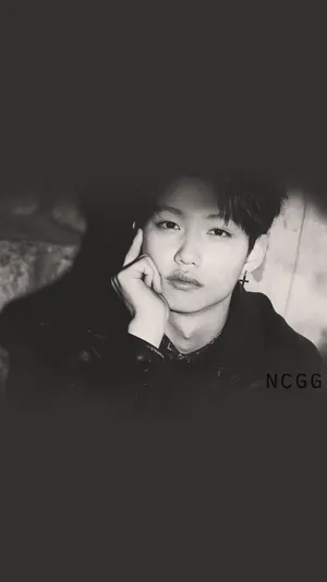 Felix Of Stray Kids Showing Off His Charismatic Charms Wallpaper