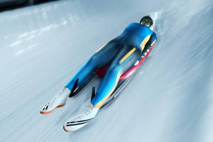 Female Luge Athlete In Blue Sportswear Wallpaper