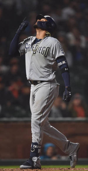 Fernando Tatis Jr Celebrates After Sliding Safely Into Home Wallpaper