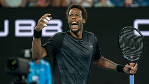 Fighting Spirit Unleashed: Gael Monfils In Action Wallpaper