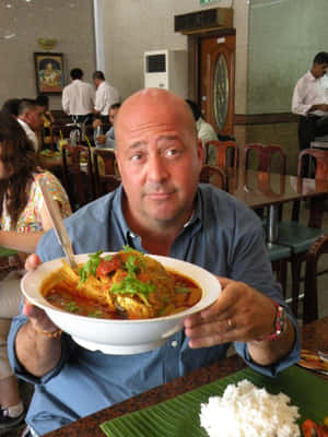 Fish Head Curry Singaporean Signature Dish Held By A Man Wallpaper