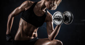 Fit Woman Lifting Dumbbell Wallpaper