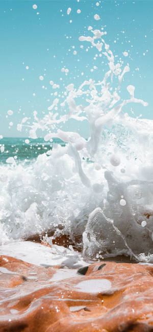 Foamy Wave On Red Sand Wallpaper