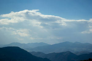 Foggy Mountains And Azure Sky Wallpaper