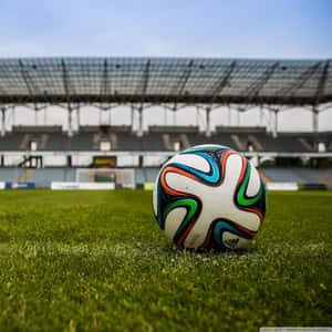 Football Galaxy Ball On Stadium Grassy Ground Wallpaper