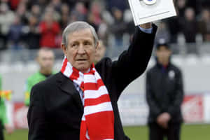 Football Legend Saluting Crowd Wallpaper