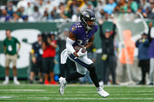 Football Player Running During Game Rainy Weather Wallpaper
