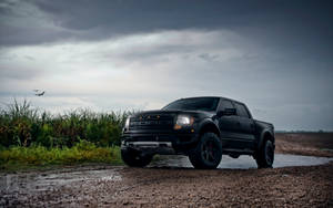 Ford Raptor Crossing A Mud Puddle Wallpaper