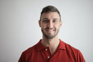 Formal Headshot Of Man Wearing Red Polo Wallpaper