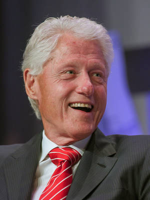 Former President Bill Clinton Spreading Positive Vibes With His Classic Grin. Wallpaper