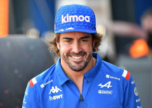 Formula 1 Legend Fernando Alonso In Blue Attire Wallpaper