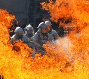 Four Firefighters Putting Out Fire Wallpaper