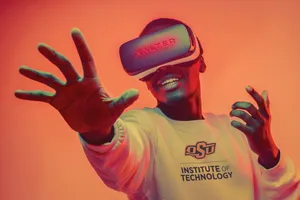 Frank Ocean Stays Connected As He Types Away On His Laptop Wallpaper