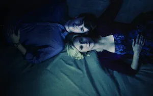 Freddie Highmore And Vera Farmiga In An Intimate Scene Wallpaper