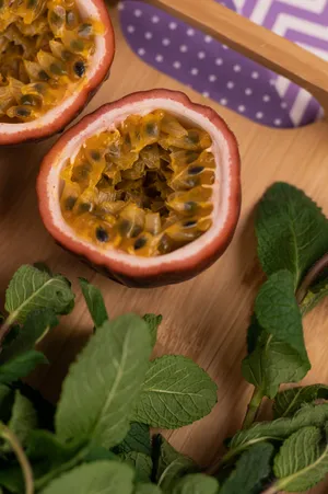 Fresh Cut Passion Fruit With Leaves Wallpaper
