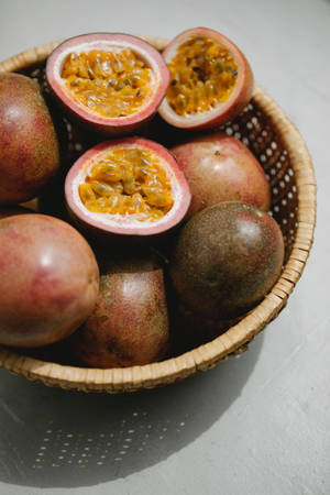 Fresh Passion Fruit In Wicker Bowl Wallpaper