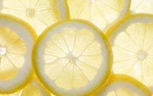 Freshly Harvested Lemons Soaking In Crisp, Cool Water. Wallpaper