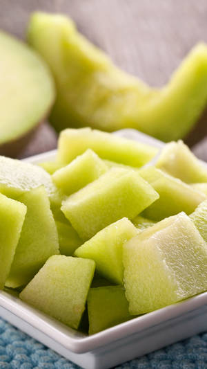 Freshly Sliced Honeydew Melon Served On A Plate Wallpaper