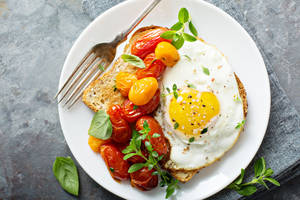 Fried Egg With A Side Of Cherry Tomato Wallpaper