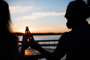 Friends Celebrate With An Ice-cold Beer Wallpaper