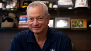 Gary Sinise Smilingin Office Setting Wallpaper