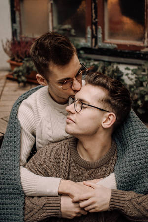 Gay Couple Cuddling With Blanket Wallpaper