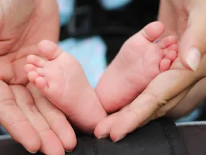 Gentle Holdof Baby Feet Wallpaper