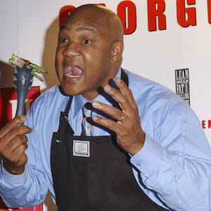 George Foreman Wearing Apron Wallpaper