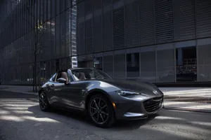 Gleaming Miata Car In Sunset Wallpaper