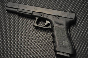 Glock 17l On Metal Surface Wallpaper