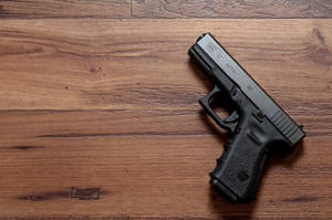 Glock 32 On Wooden Table Wallpaper