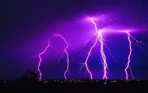 Glowing Purple Lightning At Night Wallpaper