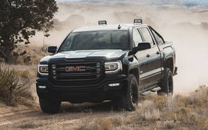 Gmc In A Sandy Area Wallpaper