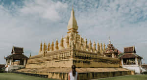 Golden Glow Of Pha That Luang Temple In Vientiane Wallpaper