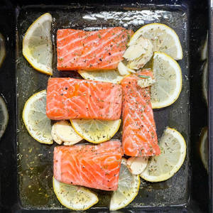 Gourmet Salmon Dish With Lemon Slices Wallpaper