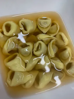 Gourmet Tortellini In Brodo In A Square Bowl Wallpaper