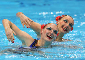 Graceful Moves Underwater: Svetlana Romashina And Natalia Ishchenko In Synchronized Swimming Competition Wallpaper