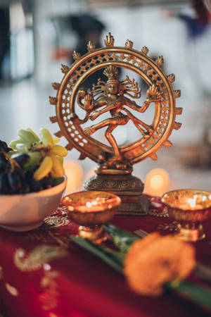 Graceful Nataraja Statue On A Decorated Altar Wallpaper