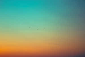 Gradient Orange And Teal Sunset Wallpaper