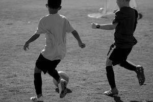 Grayscale Kids Playing Football Hd Wallpaper