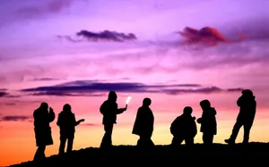Group Of Friends With Colorful Skies Wallpaper