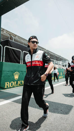 Guanyu Zhou Posing With His Cap Backwards Wallpaper