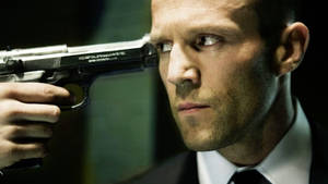 Gun Pointing To Jason Statham Wallpaper